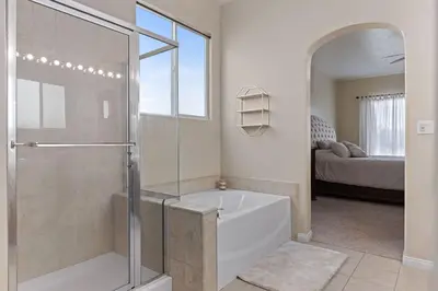 a bathroom with a shower and a bath tub at Stylish Silver Falls 4BR KING Master Game Room in Bakersfield
