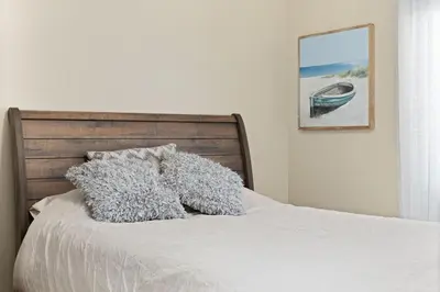 a bed with two pillows on top of it at Stylish Silver Falls 4BR KING Master Game Room in Bakersfield
