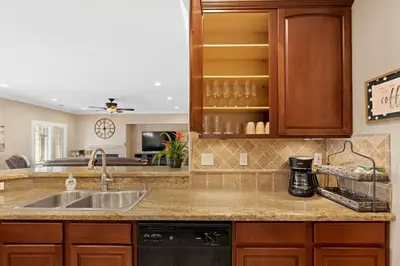 a kitchen with a sink and a counter top at Windward Bay Executive 3BR Office Home Pool in Bakersfield
