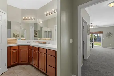 a bathroom with two sinks and a large mirror at Windward Bay Executive 3BR Office Home Pool in Bakersfield
