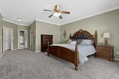 a bedroom with a bed and a ceiling fan at Windward Bay Executive 3BR Office Home Pool in Bakersfield