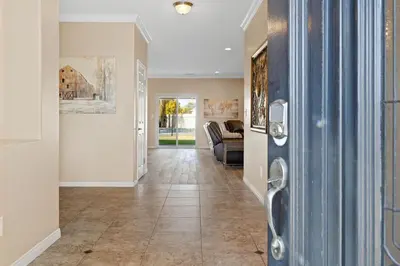 a hallway with a living room with a couch at Windward Bay Executive 3BR Office Home Pool in Bakersfield