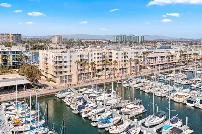 a group of boats docked in a marina with buildings at Acacia Waterfront Marina Views Pool Gym Jacuzzi And Sauna in Los Angeles