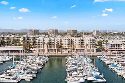 a group of boats docked in a harbor with buildings at Acacia Waterfront Marina Views Pool Gym Jacuzzi And Sauna in Los Angeles