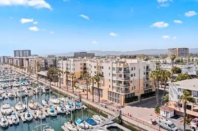 a marina with boats in the water and buildings at Acacia Waterfront Marina Views Pool Gym Jacuzzi And Sauna in Los Angeles