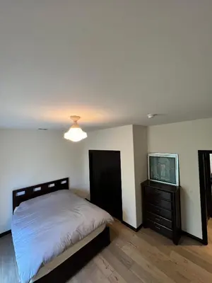 a bedroom with a bed and a dresser and a television at Beachwood in Los Angeles