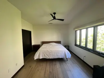 a bedroom with a bed and a ceiling fan at Beachwood in Los Angeles