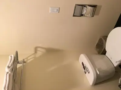 a bathroom with a toilet and a sink at Lincoln Park Motel in Los Angeles