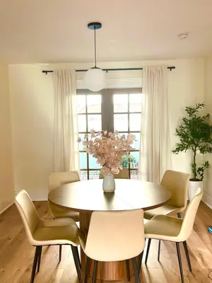 a dining room with a round table and chairs at Cozy Hollywood Cottage - Walk to Larchmont Village in Los Angeles