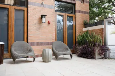 two wicker chairs sitting in front of a building at Blueground Pasadena pool AC nr City Hall LAX-1315 in Los Angeles