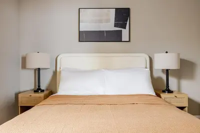 a bedroom with a white bed with two lamps at Blueground Pasadena pool AC nr City Hall LAX-1315 in Los Angeles