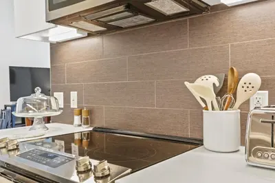 a kitchen with a counter with utensils in a vase at Stunning DTLA Gem 2 bed with pool, gym and parking in Los Angeles
