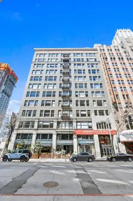 a large white building with cars parked in front of it at Stunning DTLA Gem 2 bed with pool, gym and parking in Los Angeles