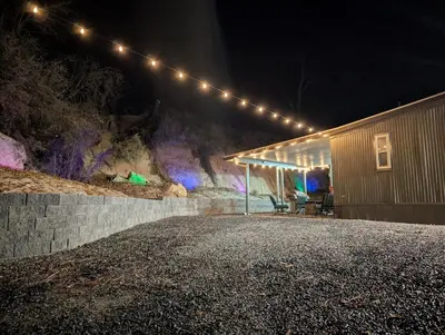 a row of lights on a building at night at Peaceful Pines Place, a cozy mountain hideaway wAC