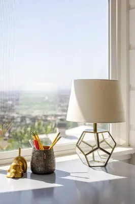 a lamp sitting on a table next to a window at Serene & beautiful bohemian hilltop retreat in Glendale