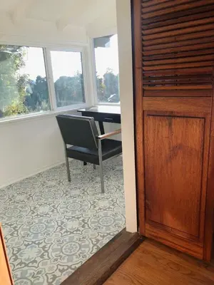 a room with a table and a chair and a window at Serene & beautiful bohemian hilltop retreat in Glendale