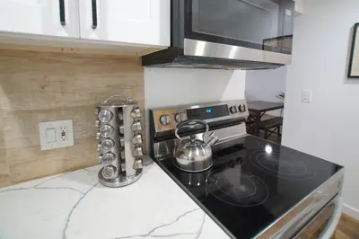 a kitchen with a stove with a tea kettle on it at Cozy Knight Cabin - AC! Walk to Lake and Village in Big Bear Lake