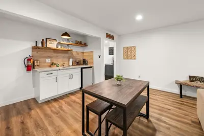 a kitchen with a wooden table and a dining room at Cozy Knight Cabin - AC! Walk to Lake and Village in Big Bear Lake