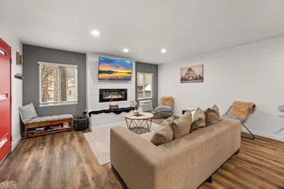 a living room with a couch and a fireplace at Cozy Knight Cabin - AC! Walk to Lake and Village in Big Bear Lake