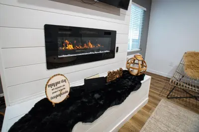 a living room with a fireplace in the wall at Cozy Knight Cabin - AC! Walk to Lake and Village in Big Bear Lake