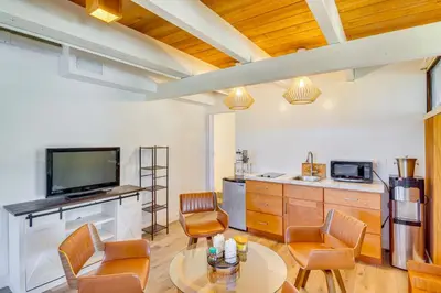 a living room with a tv and a table and chairs at Stroll to Beach and Pepperdine Airy Malibu Studio in Malibu