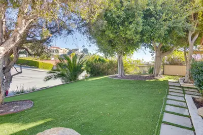 a lawn with trees and a sidewalk at Stroll to Beach and Pepperdine Airy Malibu Studio in Malibu
