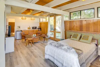 a bedroom with a bed and a kitchen and a living room at Stroll to Beach and Pepperdine Airy Malibu Studio in Malibu