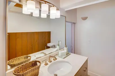 a bathroom with a sink and a large mirror at Stroll to Beach and Pepperdine Airy Malibu Studio in Malibu