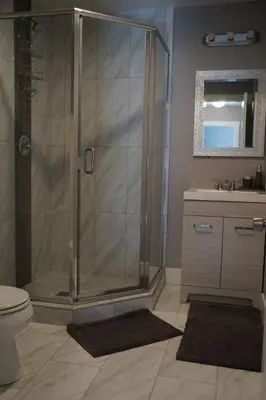 a bathroom with a shower and a toilet and a sink at The Jazz Room - Executive Suite Downtown Riverside in Riverside