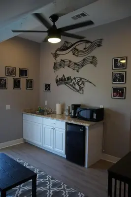 a kitchen with a counter top with a microwave and a ceiling at The Jazz Room - Executive Suite Downtown Riverside in Riverside
