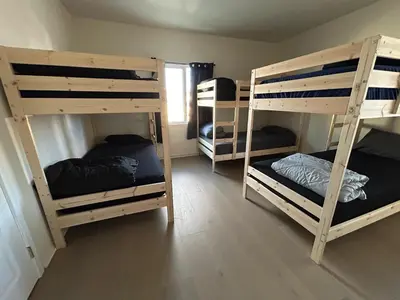 a room with three bunk beds in a room at Van Nuys Vibe in Van Nuys County Court Heliport
