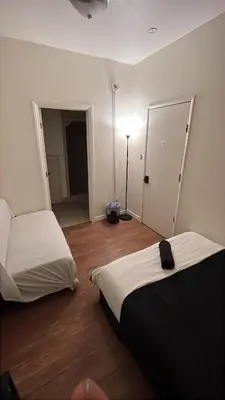 a room with two beds and a lamp in it at Van Nuys Vibe in Van Nuys County Court Heliport