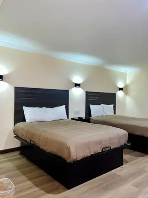 a bedroom with two beds and two lights at Del Aire Inn LAX in Inglewood
