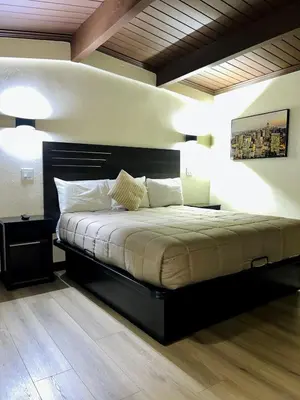 a bedroom with a large bed with two lamps at Del Aire Inn LAX in Inglewood