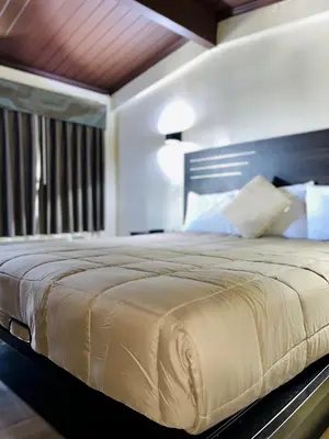a bedroom with a large bed with a wooden headboard at Del Aire Inn LAX in Inglewood