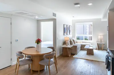 a living room with a table and chairs and a couch at Luxury 2 Bedroom 2 Bathroom Residence With Fitness and Outdoor Pool in Los Angeles