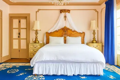 a bedroom with a large white bed with a canopy at Hollywood Deluxe Homestay in Los Angeles