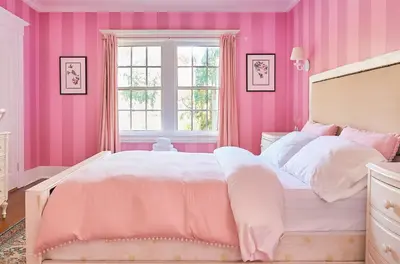 a pink bedroom with a bed and a window at Hollywood Deluxe Homestay in Los Angeles