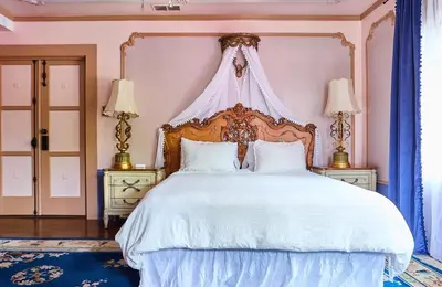 a bedroom with a large white bed with a canopy at Luxurious Hollywood Homestay in Los Angeles