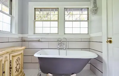 a bath tub in a bathroom with two windows at Luxurious Hollywood Homestay in Los Angeles