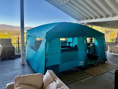 a blue tent on a deck with a couch at Glamping Cabin Tent Heated View Deck 2Acre Estate - Female Share Indoor - Men Share Outdoor - RG in Encino