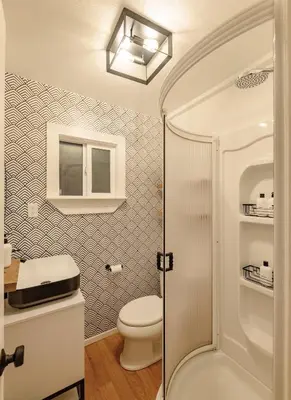 a bathroom with a toilet and a shower at Little Wolf Lodge Modern Cabin at Lake Gregory in Crestline