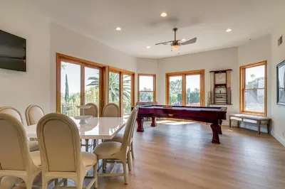 a dining room with a pool table and chairs at Play, Swim and Unwind Luxe Los Angeles Oasis! in Chatsworth Lake Manor