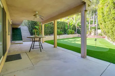 a patio with a golf course in the background at Play, Swim and Unwind Luxe Los Angeles Oasis! in Chatsworth Lake Manor