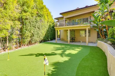 a yard of a house with a flag in the grass at Play, Swim and Unwind Luxe Los Angeles Oasis! in Chatsworth Lake Manor