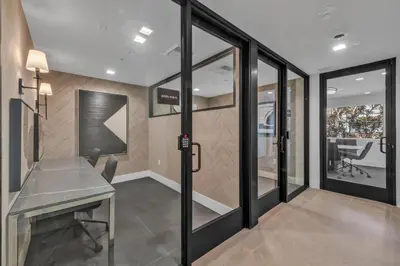 a room with sliding glass doors and a desk at Global Luxury Suites in LA's Seaside in Los Angeles