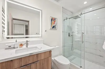 a bathroom with a shower and a sink and a toilet at Modern New 3B Home Fully Stocked & Cozy & Sunlight