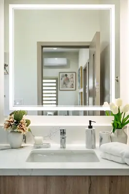 a bathroom with a sink and a large mirror at Cozy Modern Home w Full Kitchen & Parking