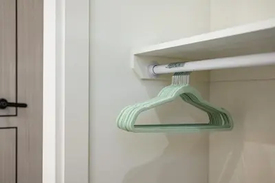 a green glass door hanger with a toothbrush in it at Cozy Modern Home w Full Kitchen & Parking