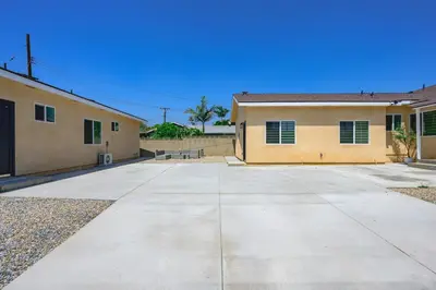 an empty parking lot in front of a building at Cozy Modern Home w Full Kitchen & Parking